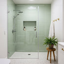 Modern bathroom with glass shower and green tiles
