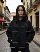 Fashionable Woman Wearing Black Hoodie in Urban City Street