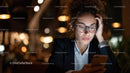Young woman with glasses using smartphone in a cozy urban setting