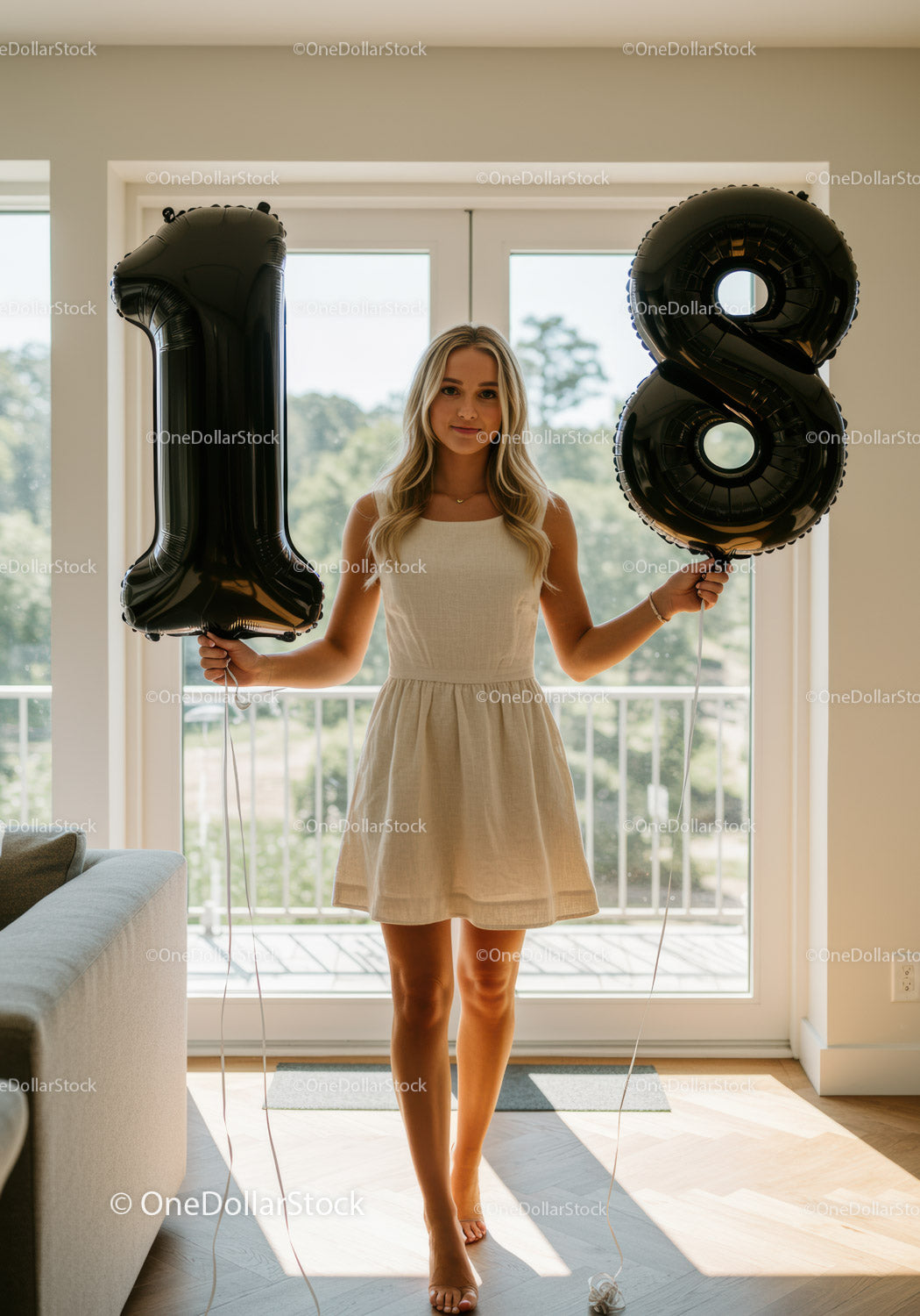 Young woman celebrating 18th birthday with balloons