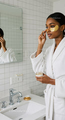 Woman Applying Facial Mask in Modern Bathroom for Skincare Routine