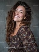 Portrait of a Smiling Woman in Floral Top with Wavy Hair
