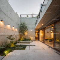 Modern Concrete Patio with Greenery and Outdoor Lighting