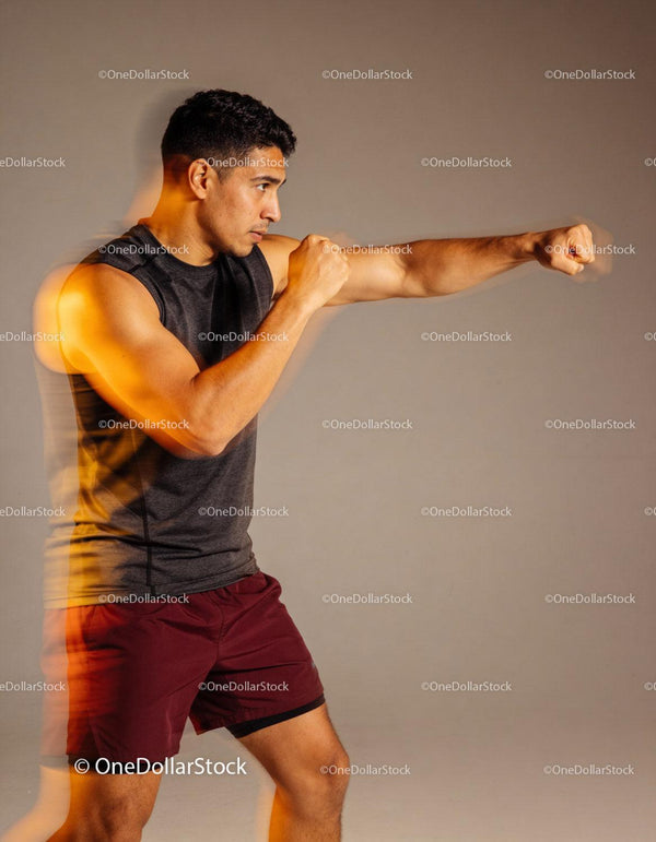 Young man focused on precise boxing punch technique