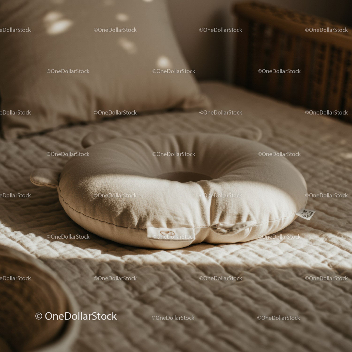 Soft Beige Pillow on Cozy Quilted Bed in Warm Light