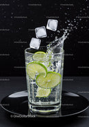 Refreshing sparkling water with lime and ice cubes splash