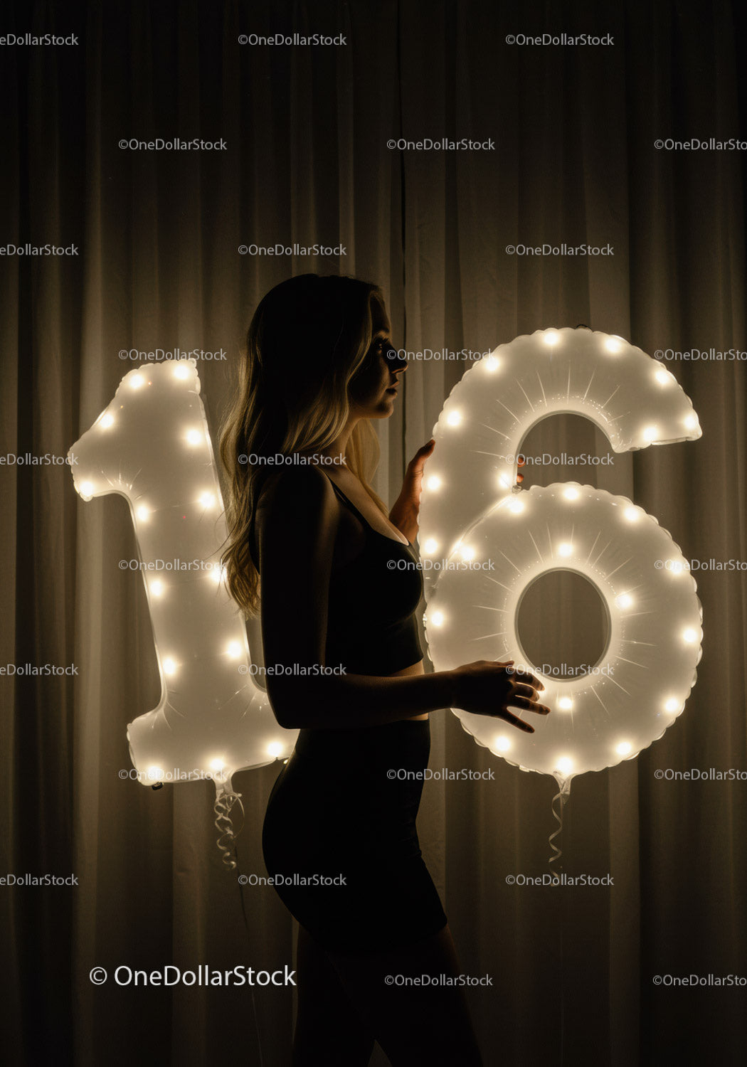Young woman celebrating sixteenth birthday with lights