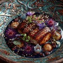 Gourmet Glazed Pork Belly with Edible Flowers and Microgreens