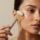 Close-Up of Woman Using Facial Roller for Skin Care Treatment