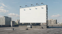 Large blank billboard on urban rooftop with city view