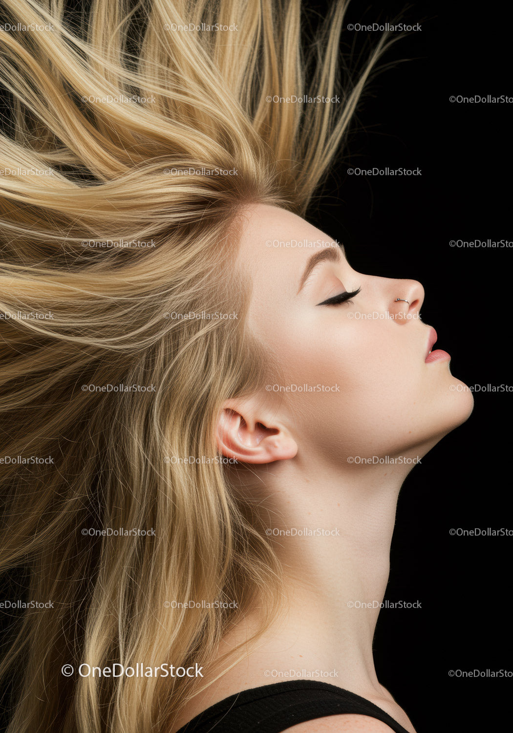 Blonde woman with flowing hair and closed eyes profile
