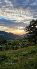 Scenic Sunset Over Green Mountain Valley with Lush Forest
