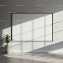 Minimalist interior with blank framed canvas and plant