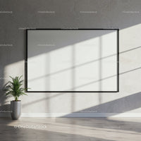 Minimalist interior with blank framed canvas and plant
