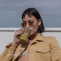 Stylish Young Woman Drinking Smoothie in Outdoor Setting