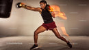 Focused woman boxer throwing powerful punch in gym
