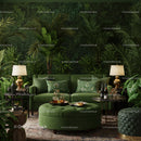 Cozy living room with lush greenery and green velvet sofa