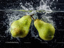 Fresh Green Pears Splashing into Water with Dynamic Motion