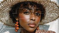Elegant Woman in Straw Hat and Summer Outfit Outdoors