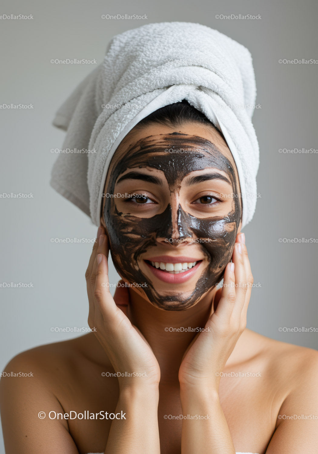 Woman with Facial Mask and Towel After Skincare Treatment