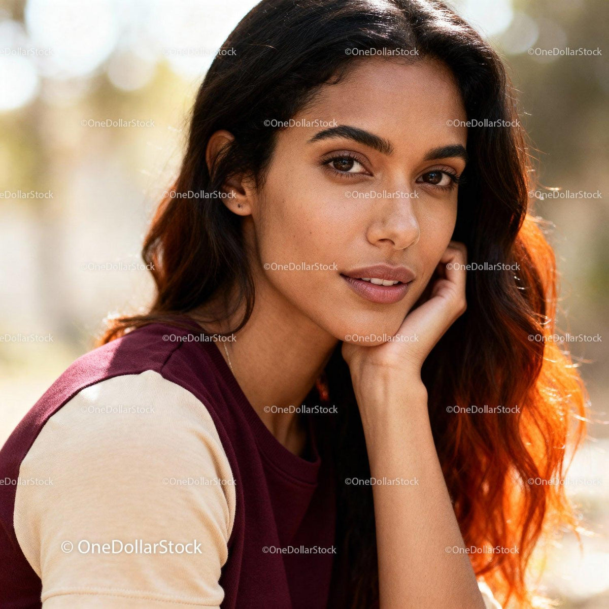 Young woman with thoughtful expression resting outdoors
