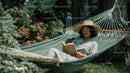 Relaxing Woman Reading in Hammock in a Garden