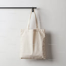 Minimalist Beige Cotton Tote Bag Hanging on Wall Hook