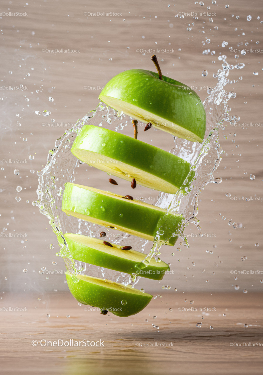 Sliced green apple levitating with water splash