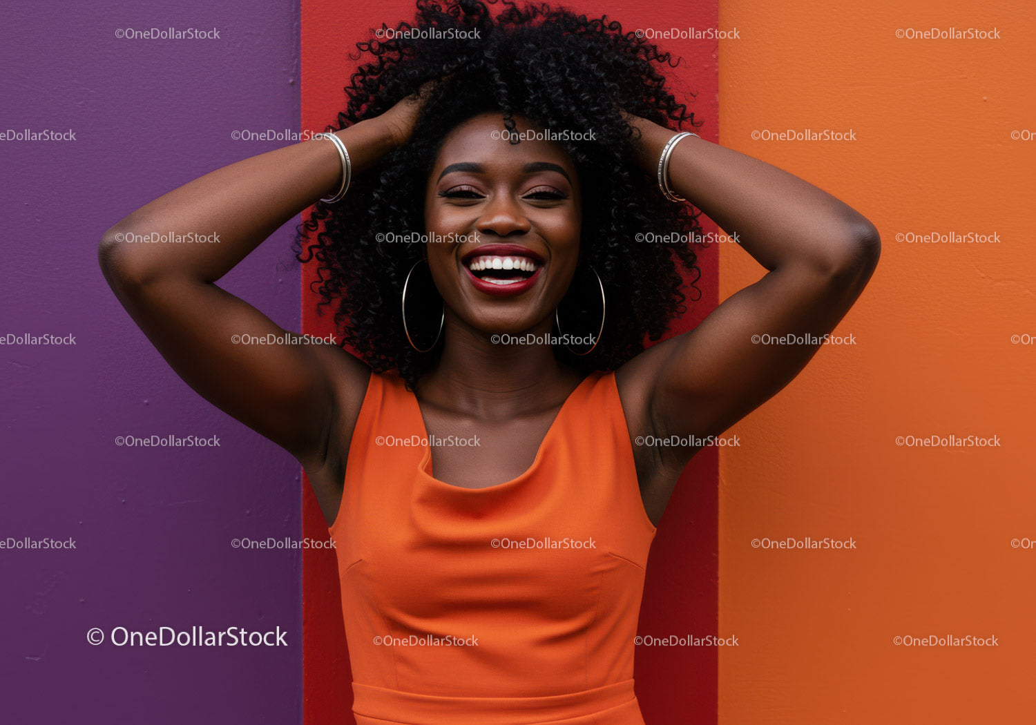 Joyful Woman in Orange Dress with Curly Hair Against Colorful Wall