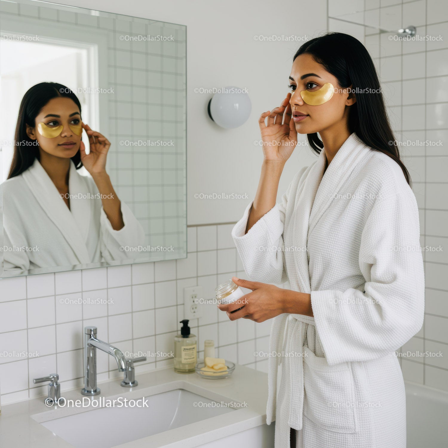 Elegant Woman Applying Skincare Cream in Bright Modern Bathroom