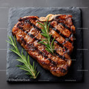 Gourmet Grilled Steak with Rosemary on Black Slate Plate