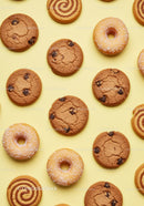 Assorted Cookies and Donuts on Yellow Background