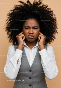 Frustrated Woman Covers Ears Against Noise in Business Attire