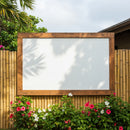 Empty Wooden Frame on Bamboo Fence with Colorful Flowers