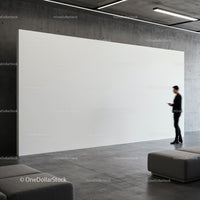 Man using smartphone near empty white art wall in gallery