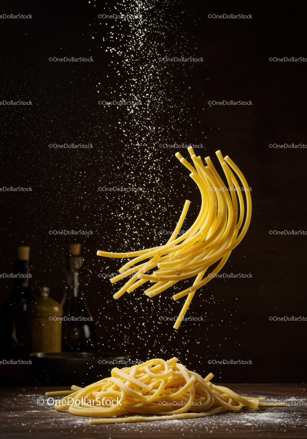 Fresh pasta strands with flour falling on wooden surface