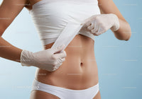 Woman Removing Medical Tape from Skin During Healthcare Procedure