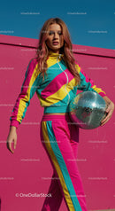 Stylish Woman in Colorful Tracksuit Holding Disco Ball Outdoors
