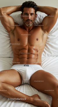 Fit man relaxing on bed in white underwear