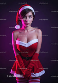 Young woman in festive Santa outfit with striped stockings