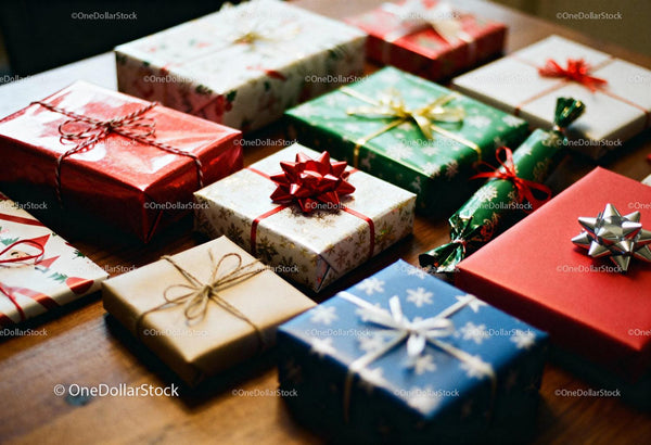 Diverse Christmas gifts wrapped in festive paper on table