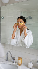 Woman Applying Eye Masks in Modern Bathroom for Skincare Routine