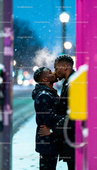 Couple sharing a tender kiss on snowy city street