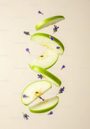 Slices of green apple with delicate purple flowers