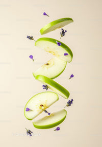 Slices of green apple with delicate purple flowers