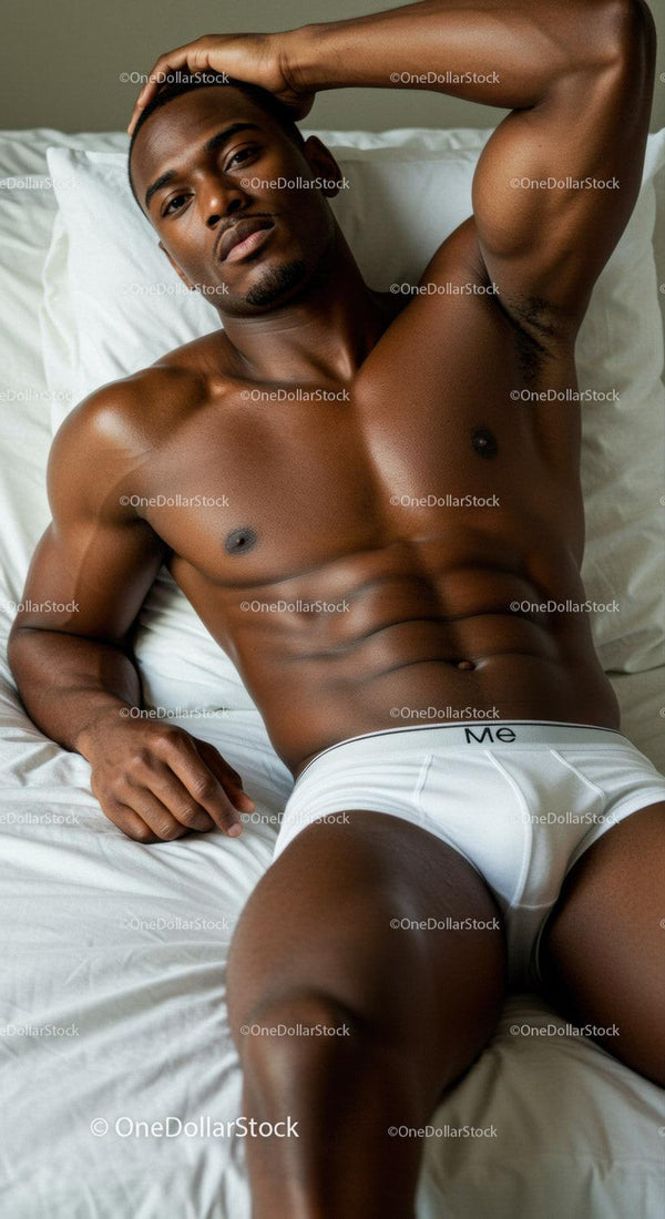 Relaxed muscular man lying on bed in white underwear
