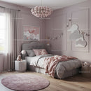 Cozy Pink Children's Bedroom with Cloud Wall Decor and Plush Toys