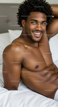 Smiling man relaxing on bed in bright cozy room