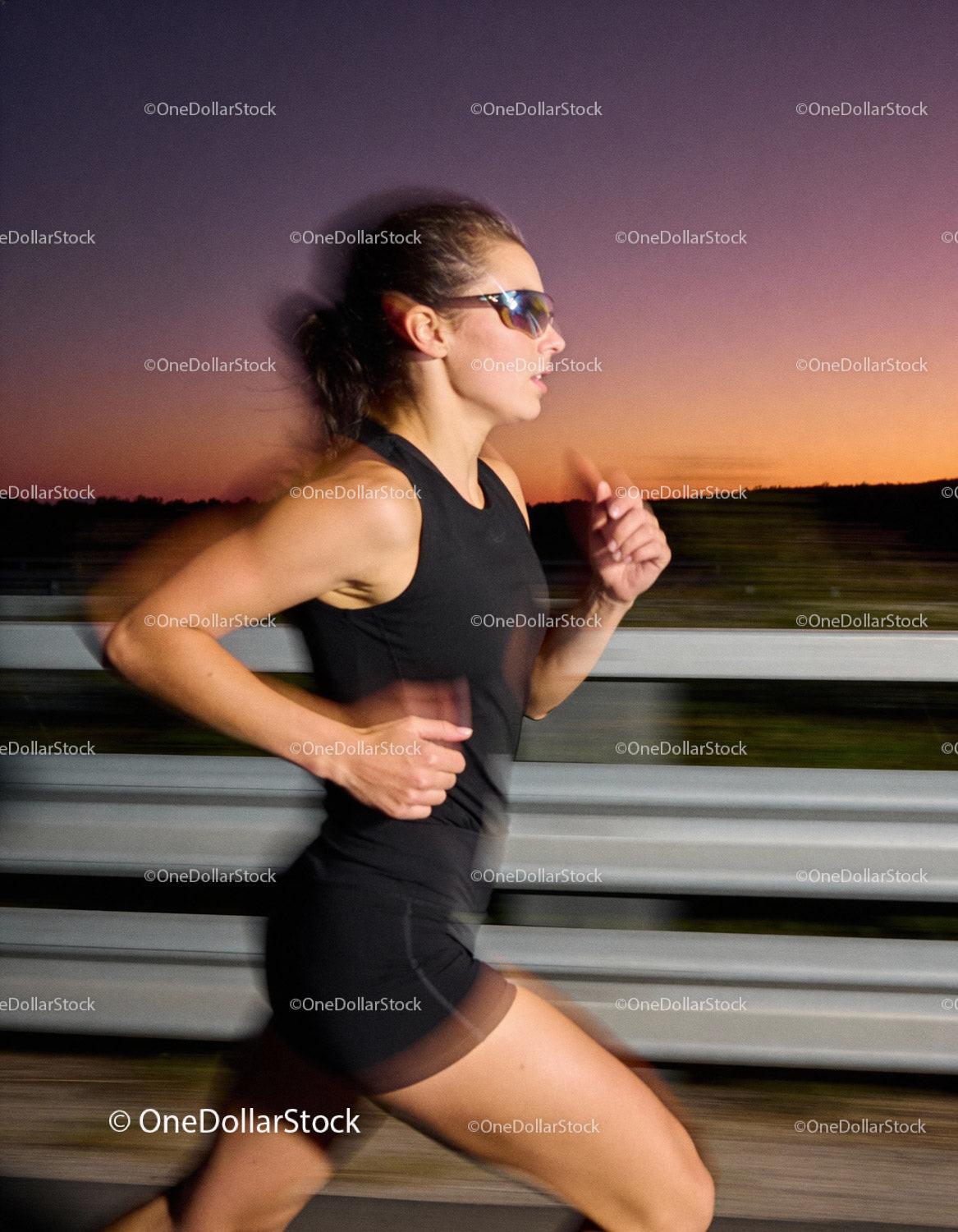 Female runner training outdoors during vibrant sunset