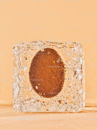 Frozen Brown Coffee Pod Encased in Transparent Ice Cube